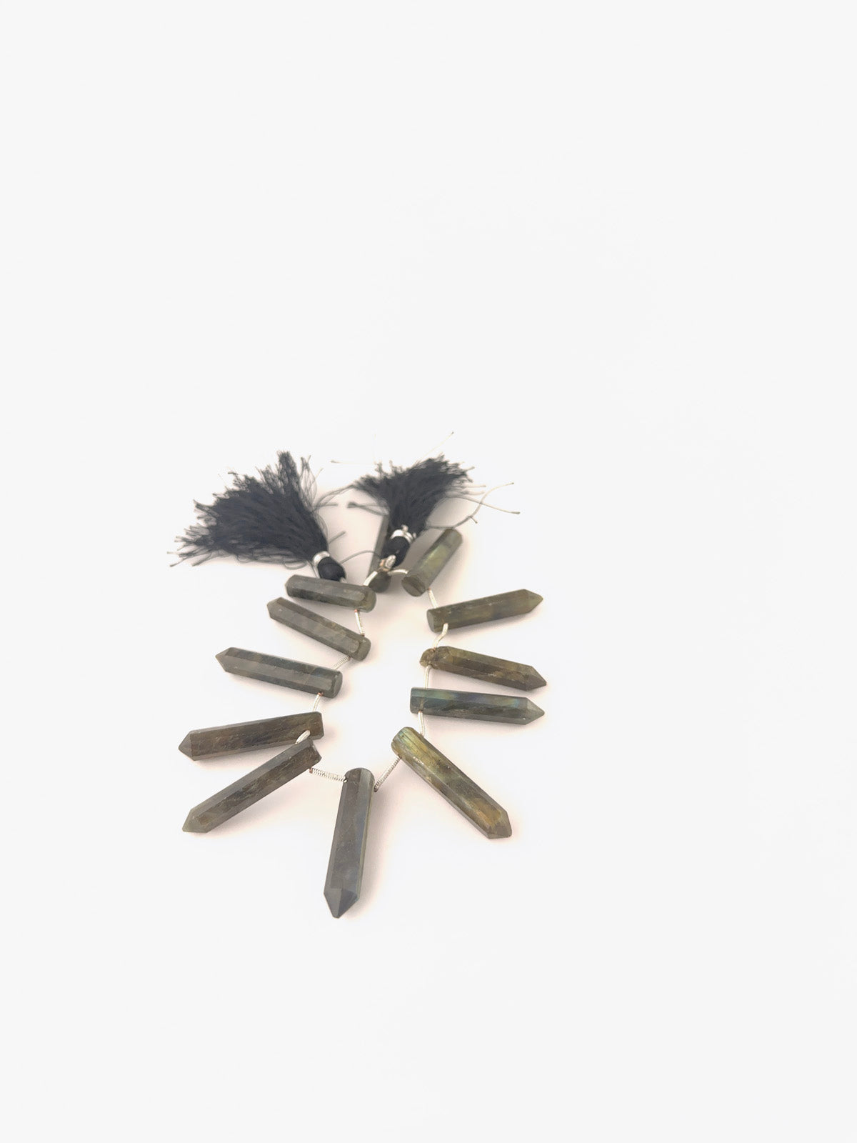 Labradorite briolette beads featuring clean angular cuts, subtle colour play, and consistent 6–7mm sizing.