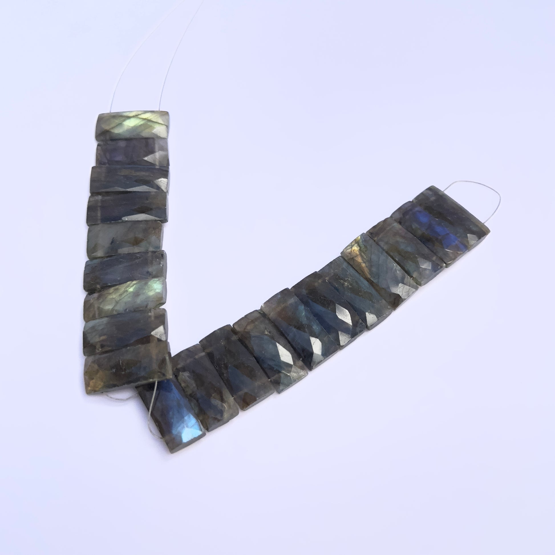 labradorite faceted rectangle gemstone beads on white background.