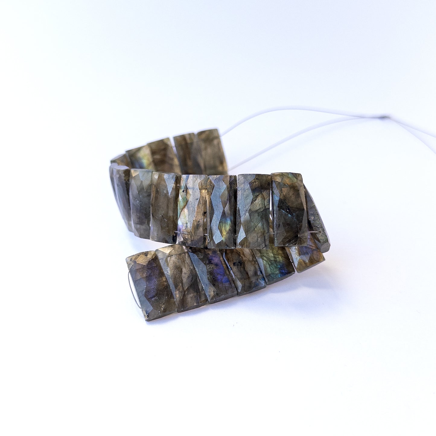 Authentic labradorite gemstone beads featuring iridescent labradorescence and sharp faceted edges.