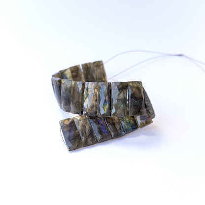 Authentic labradorite gemstone beads featuring iridescent labradorescence and sharp faceted edges.