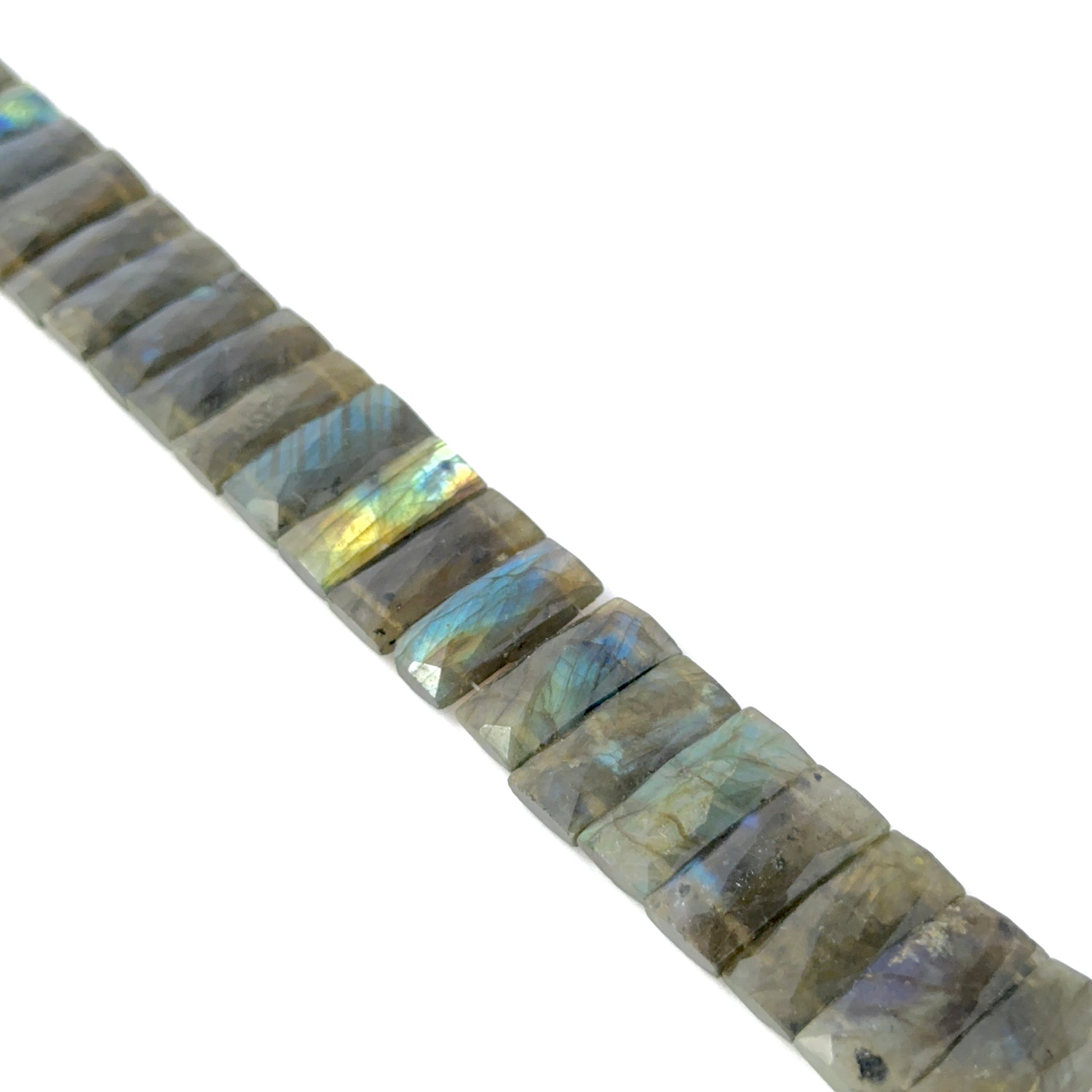 Faceted rectangle Labradorite stone beads arranged neatly, highlighting their colour play of the faceted rectangle beads.