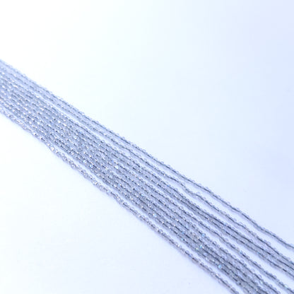 Strands of Labradorite faceted rondelle gemstone beads arranged neatly, showcasing their shimmer and fine cut.