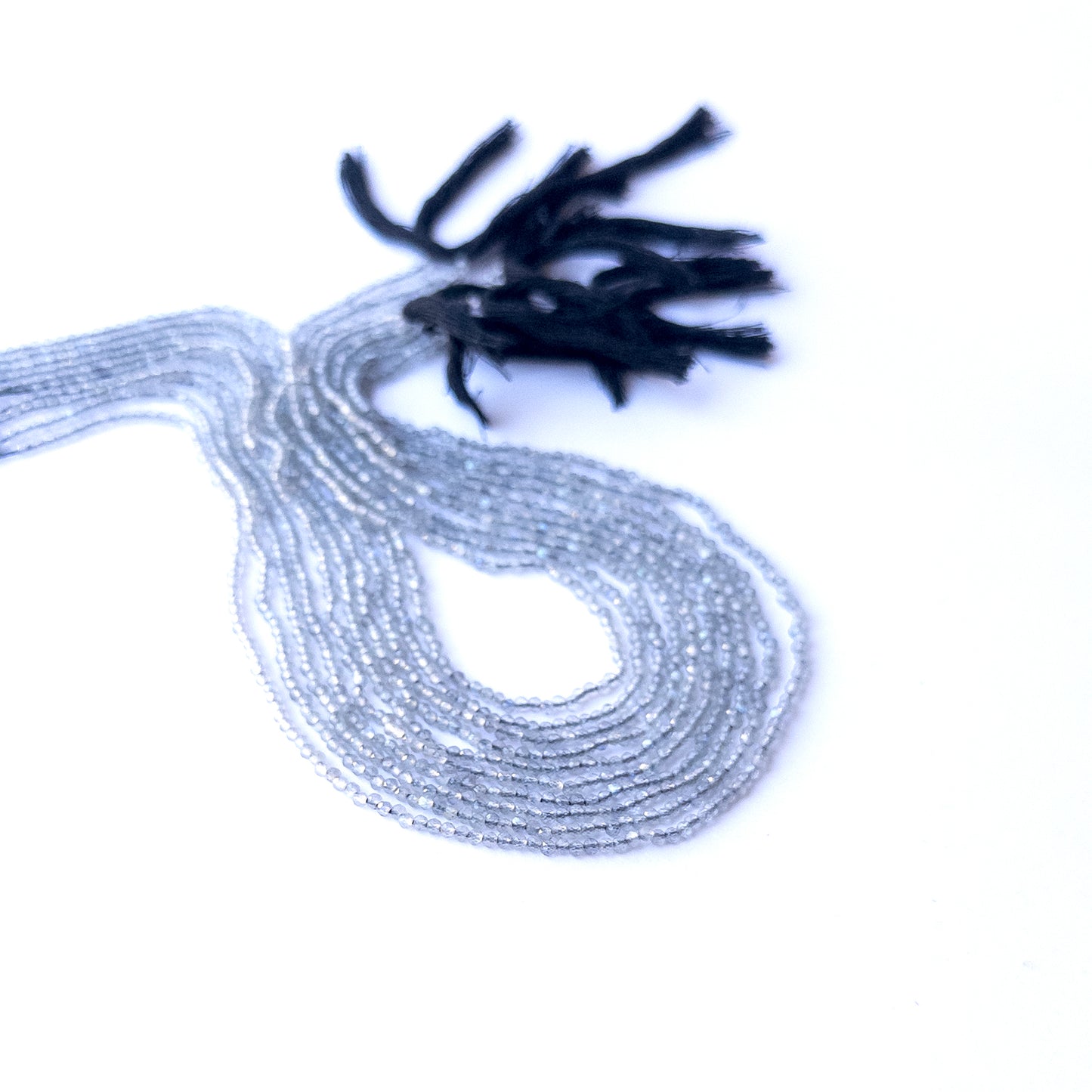 Labradorite faceted rondelle beads displayed in multiple strands, showing consistent 2.1mm sizing and natural colour variation.