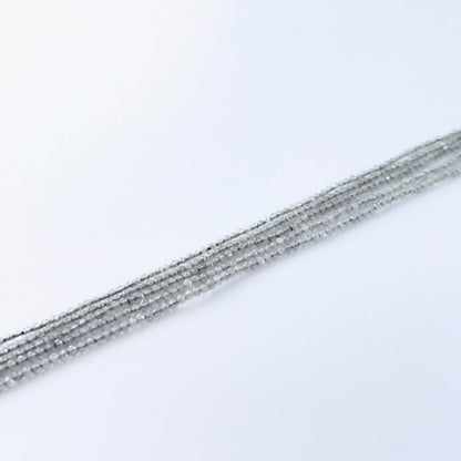 Labradorite faceted rondelle beads showing soft flashes of blue and green.