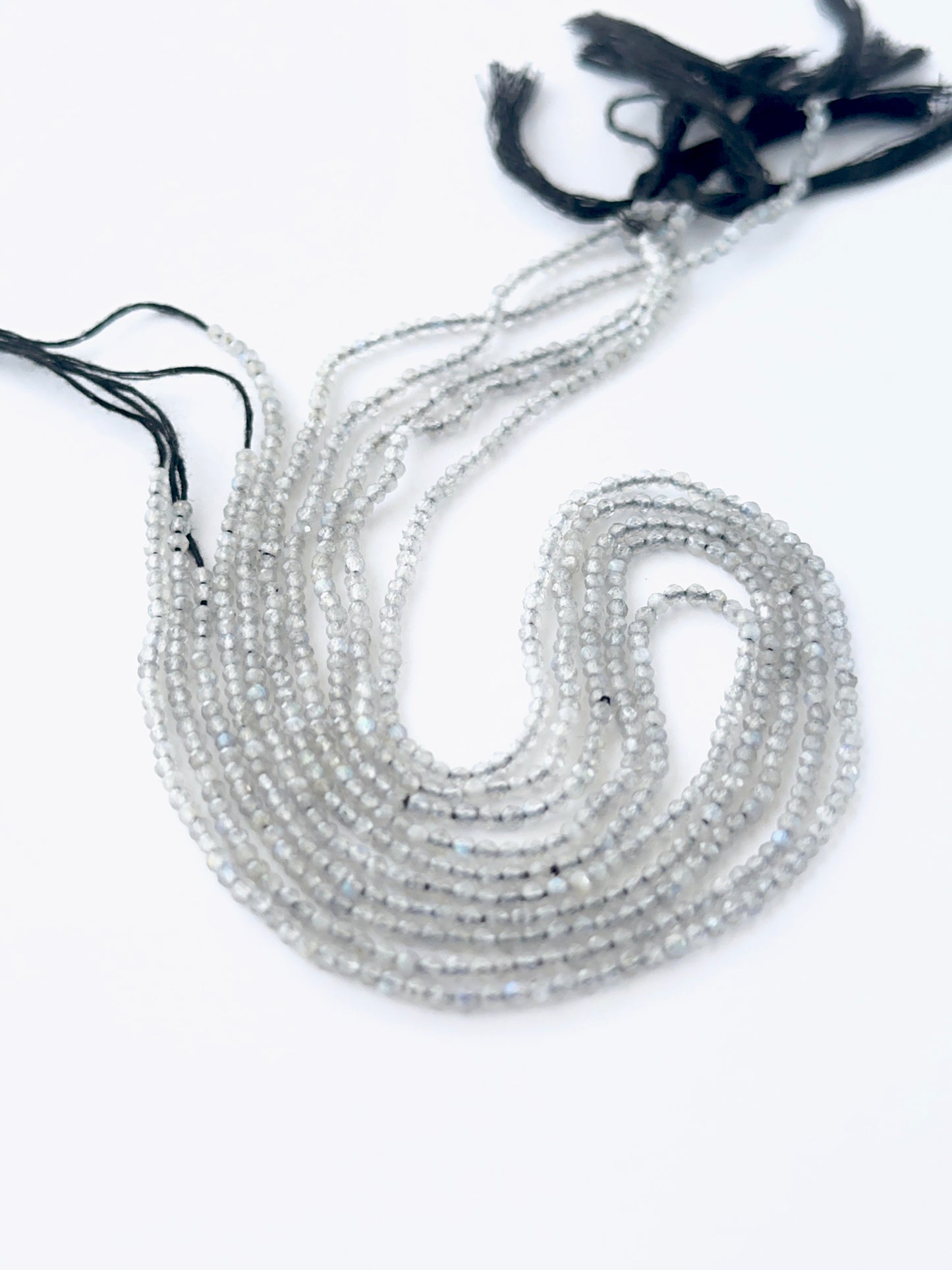 Labradorite faceted rondelle beads in a long strand, displaying consistent size and refined craftsmanship