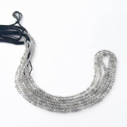 Small Labradorite faceted rondelles arranged neatly, highlighting their sparkle and handmade jewellery component quality