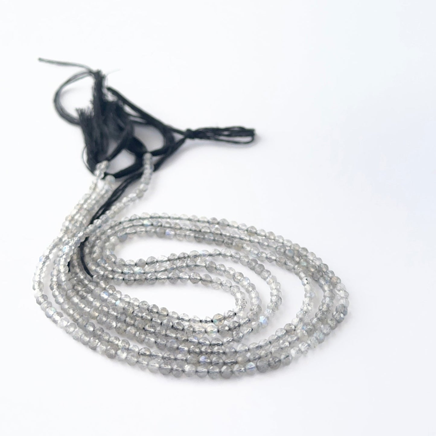 Labradorite faceted rondelle beads in a long strand, displaying consistent size and refined craftsmanship