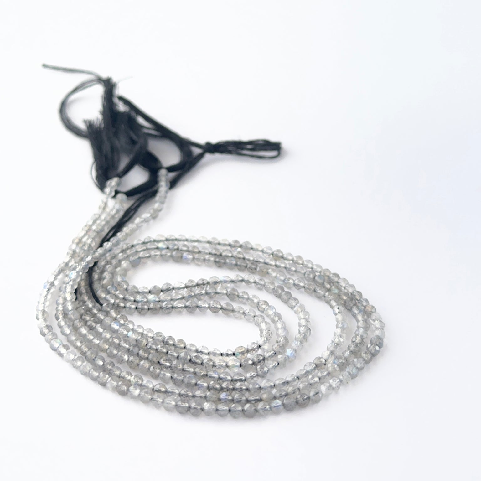 Labradorite faceted rondelle beads in a long strand, displaying consistent size and refined craftsmanship