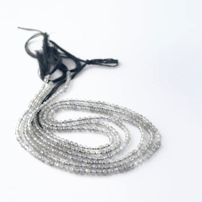 Labradorite faceted rondelle beads in a long strand, displaying consistent size and refined craftsmanship