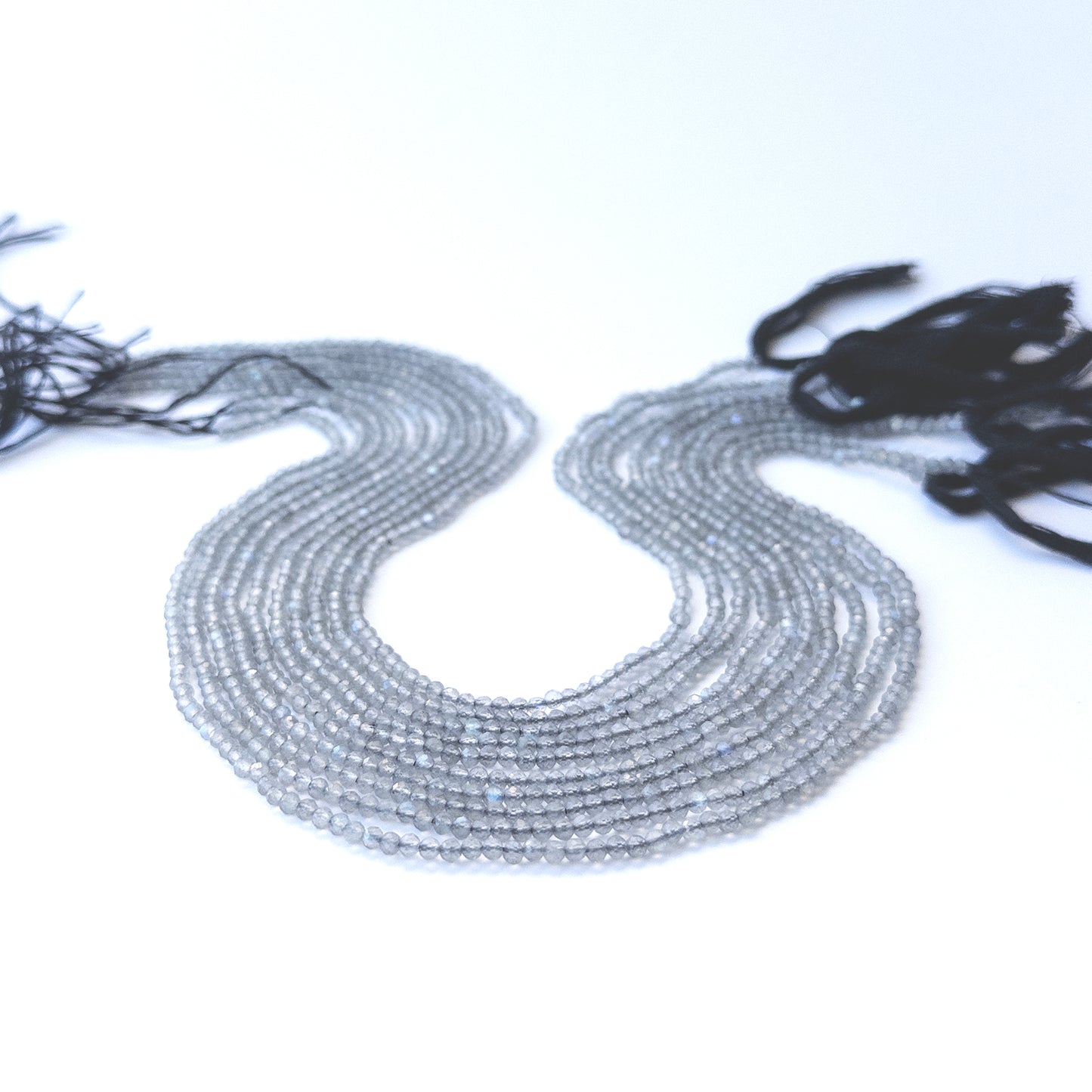 Authentic labradorite stone beads in fine faceted rondelle cuts showing polished sparkle for jewellery design work.