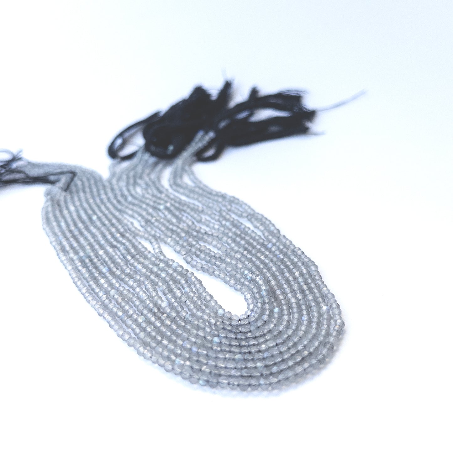 Strand of labradorite faceted rondelles displaying grey‑blue tones and quality cut for gemstone beads for DIY jewellery.