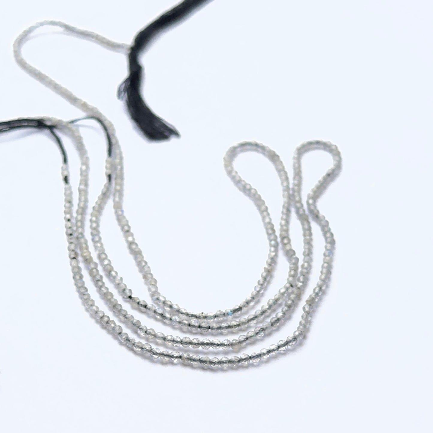 Close‑up of Green Opal stone beads in faceted rondelle cut, highlighting gentle shimmer for handmade jewellery components.