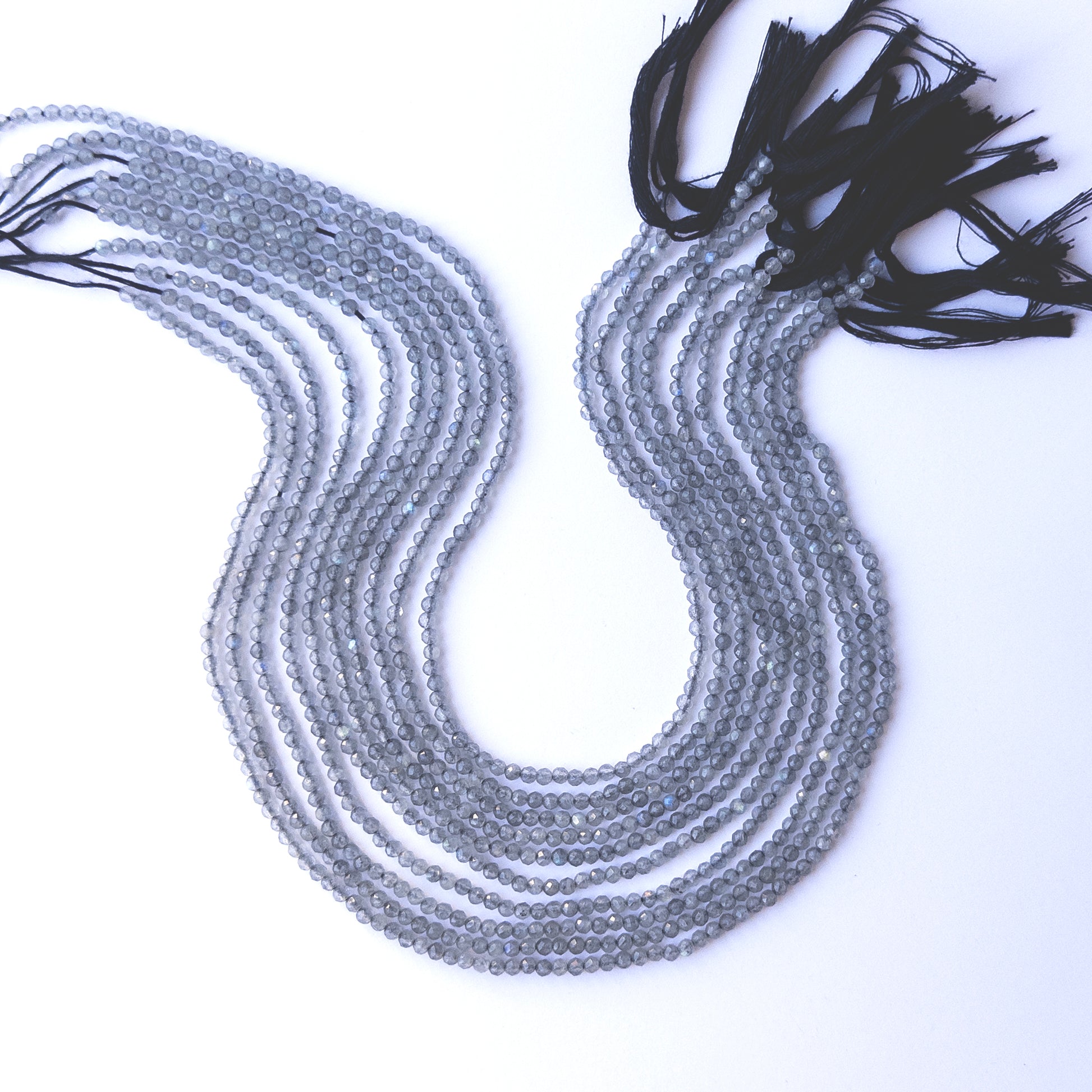 Labradorite faceted rondelle beads with natural variation, perfect for handmade jewellery components and creative beadwork.