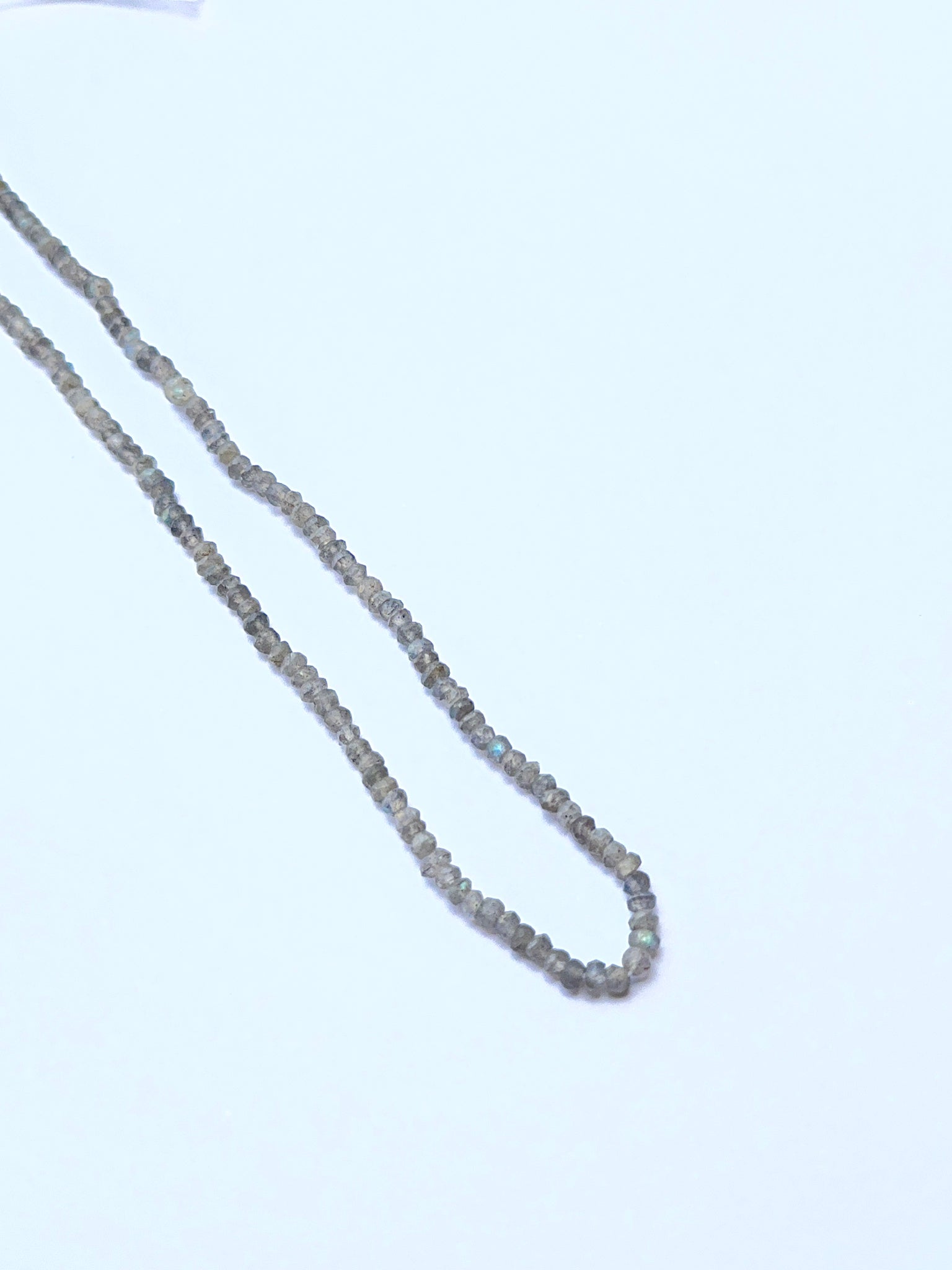 Labradorite natural gemstone beads in faceted rondelle shape, ideal for artisan jewellery and creative DIY beadwork.