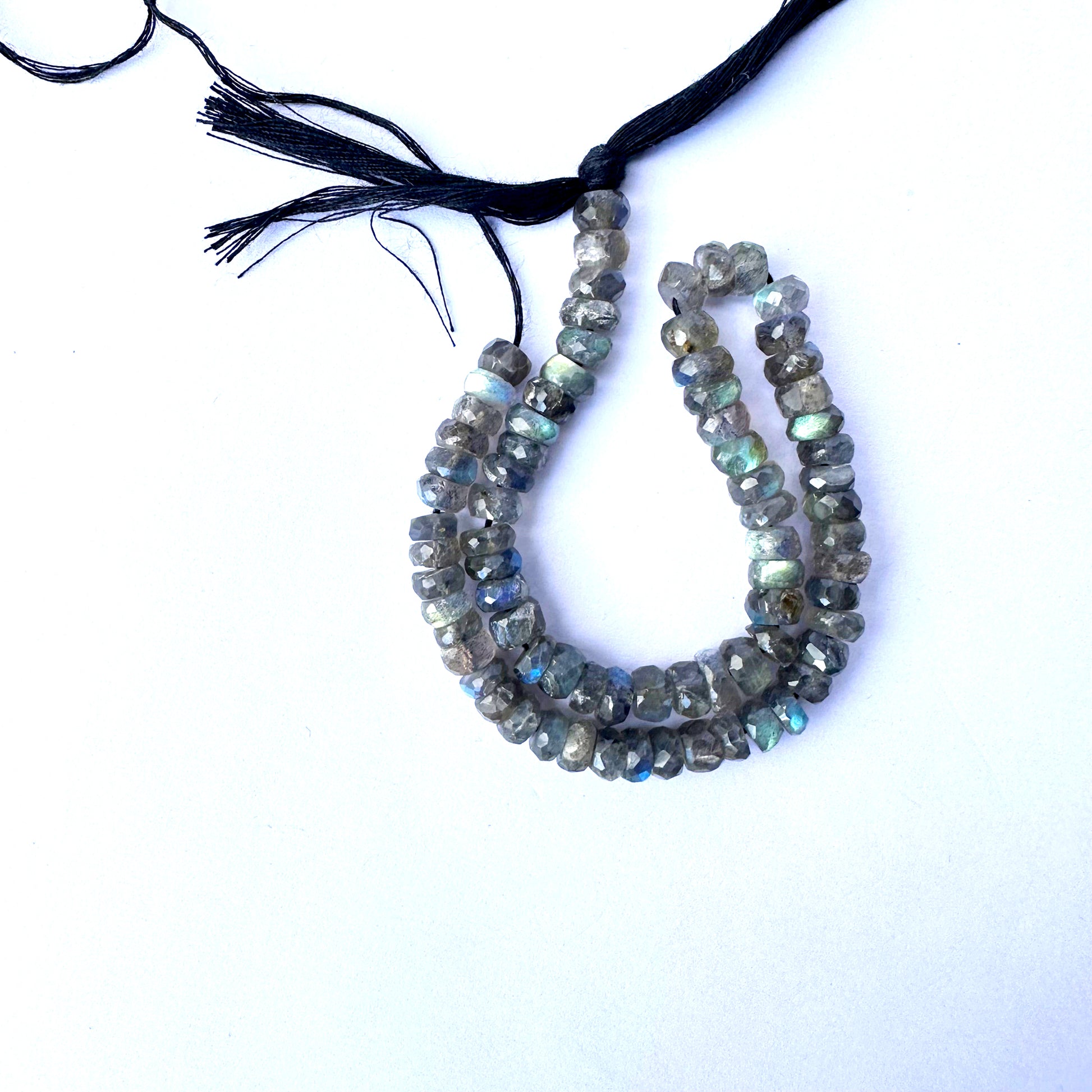 Close-up of 6.3-6.5mm Labradorite beads arranged in a 26cm strand.