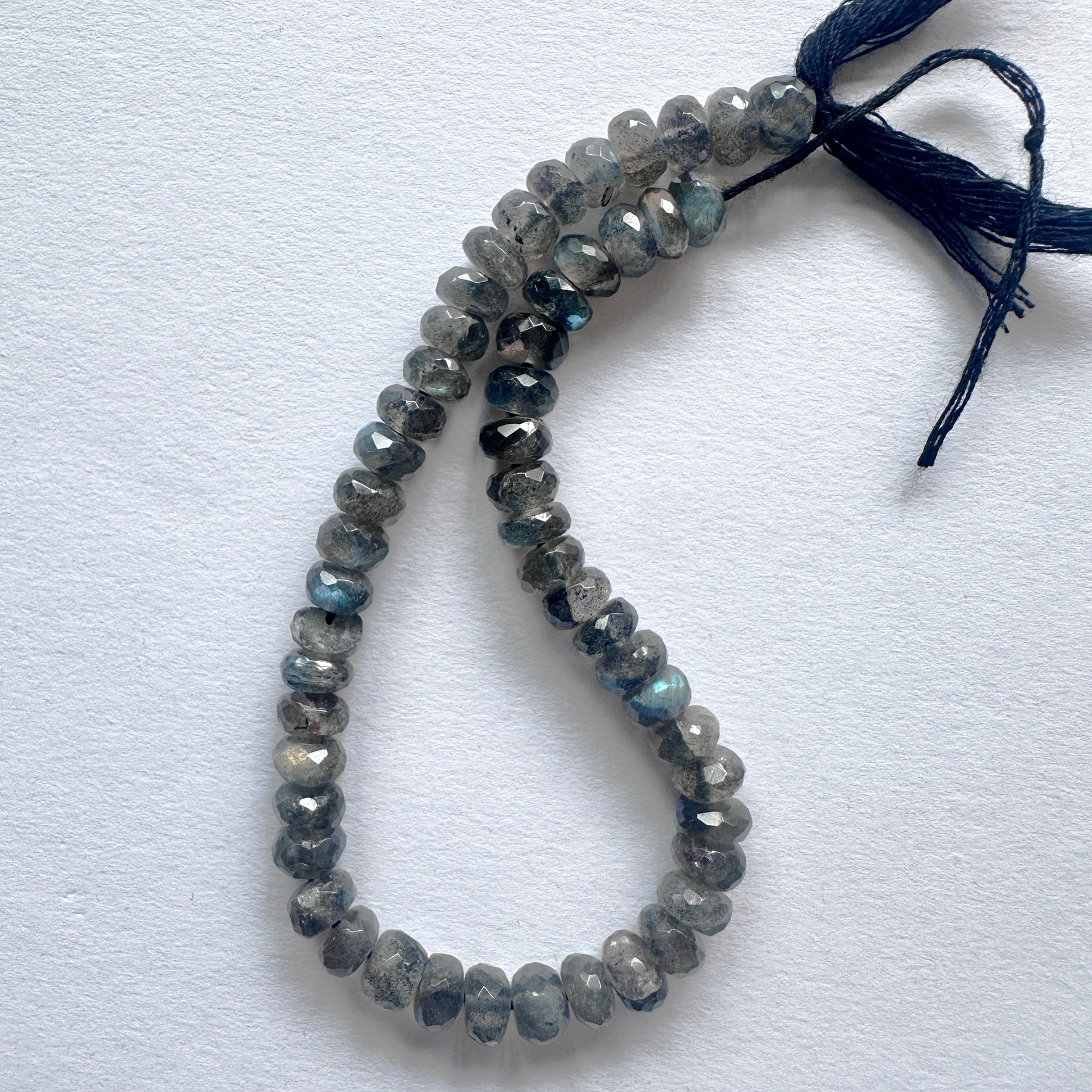 Close-up of Labradorite beads showcasing their shimmering hues and detailed cut.