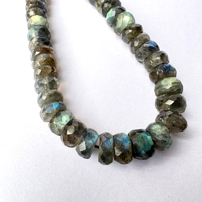 Close-up of Labradorite beads showing precise faceting and natural iridescent glow.