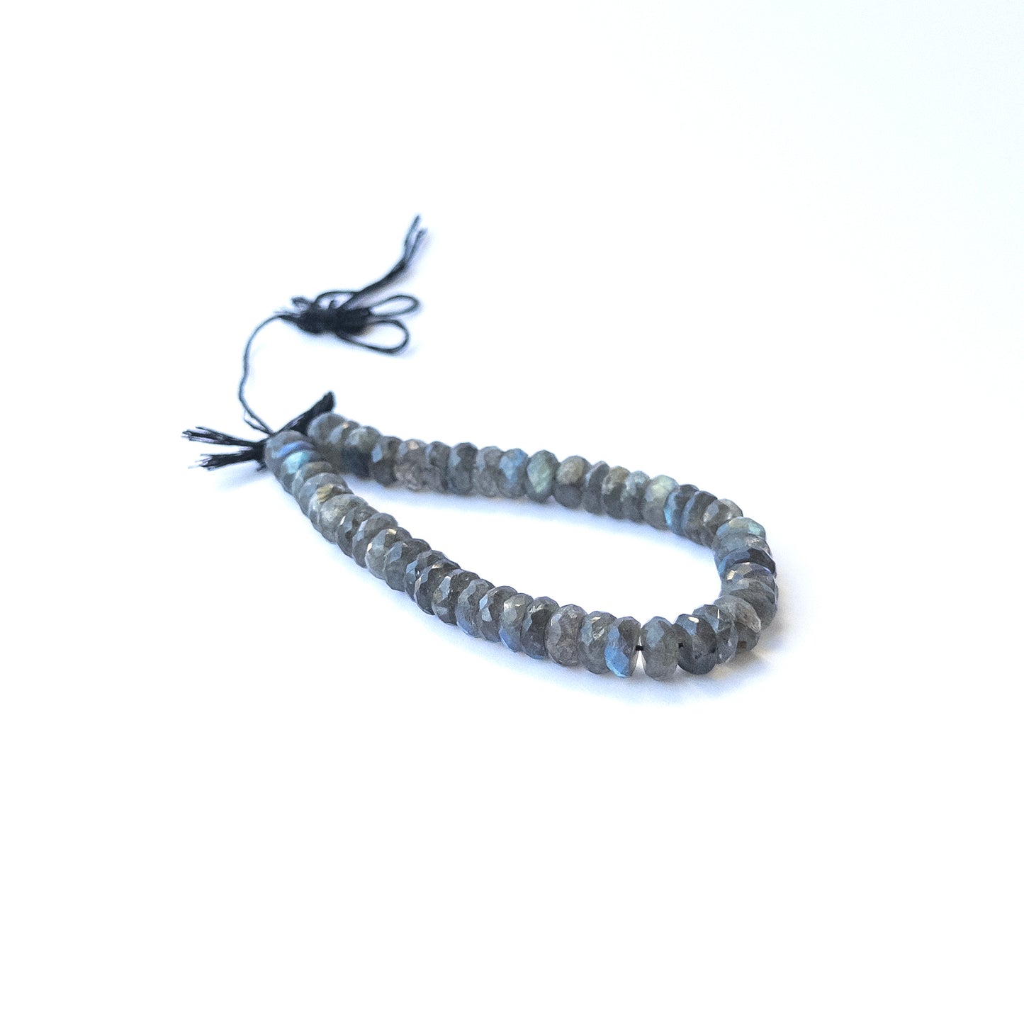 Authentic labradorite stone beads in large faceted rondelle cuts showing polished sparkle for jewellery design work.