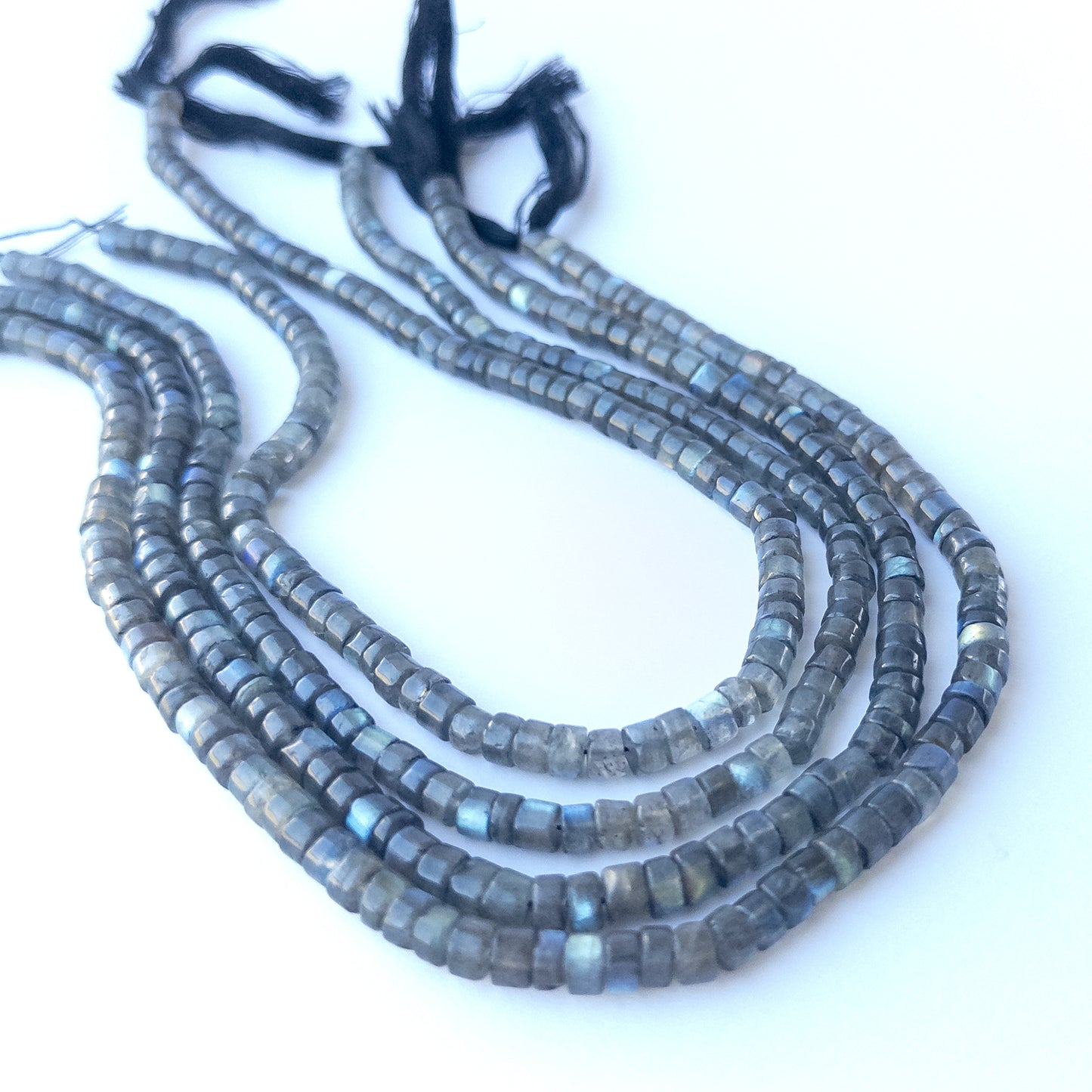 Natural Labradorite smooth cylinder stone beads 5.5–5.7mm displayed neatly for DIY jewellery and authentic gemstone designs.