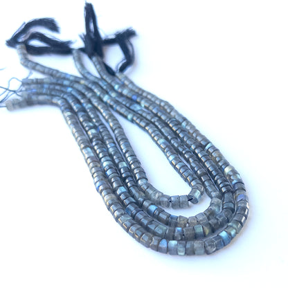 Labradorite smooth cylinder 5.5–5.7mm genuine gemstone beads arranged in a shimmering 32cm strand for handmade jewellery.