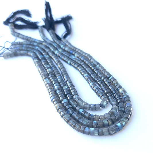Labradorite smooth cylinder 5.5–5.7mm genuine gemstone beads arranged in a shimmering 32cm strand for handmade jewellery.