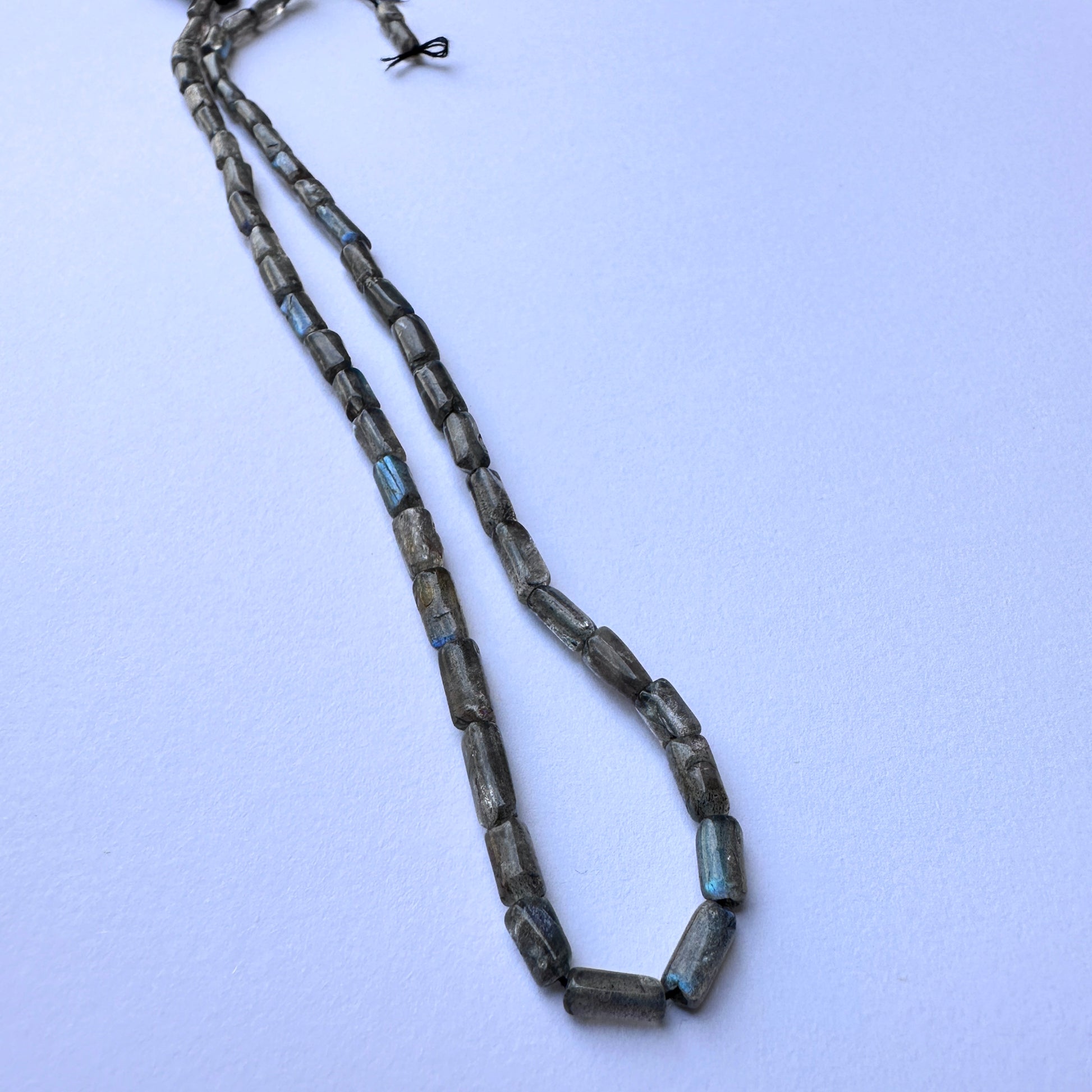Handmade jewellery components showcasing labradorite beads with 0.5mm holes and premium natural gemstone quality.