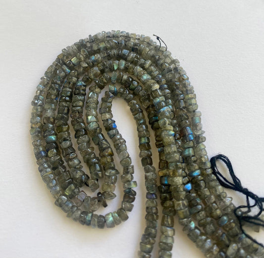 Labradorite smooth wheel beads with stunning flashes of blue and green arranged on a 33cm strand.