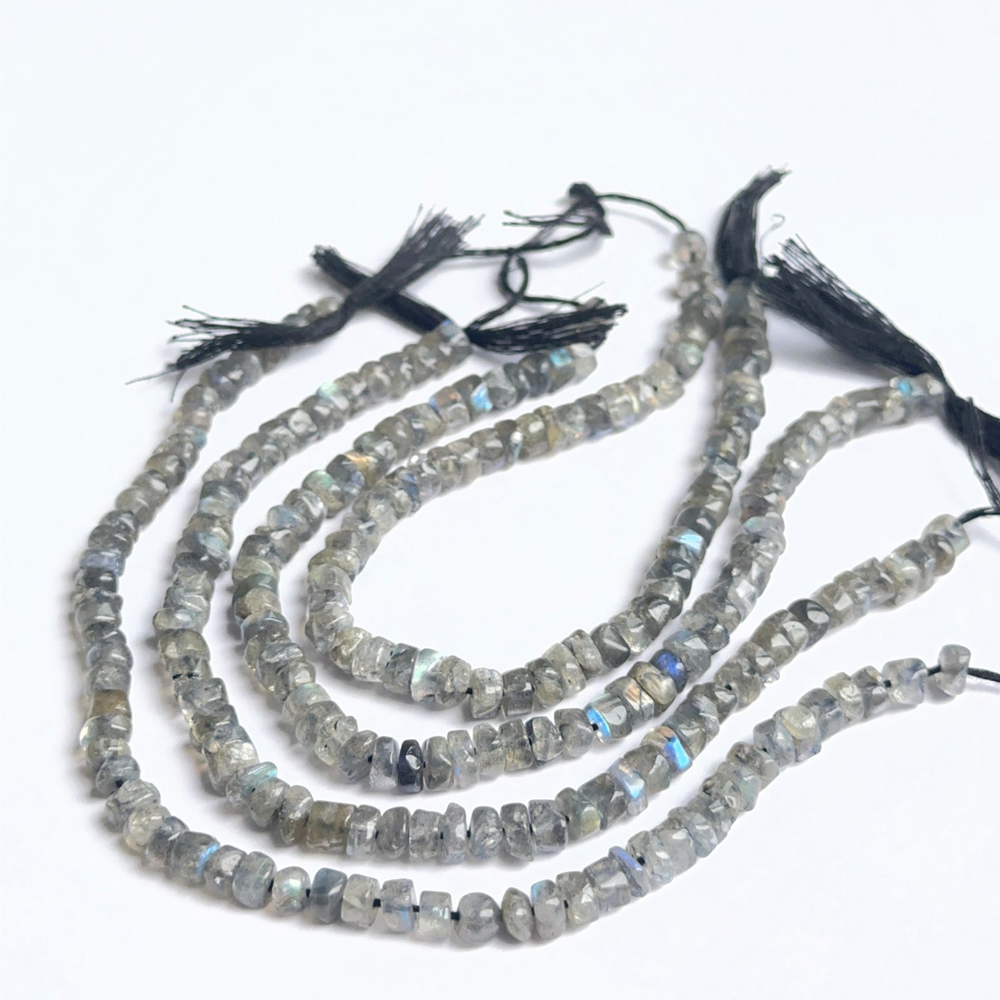 Labradorite smooth wheel heishi beads showing natural flash and polished surfaces for handmade jewellery.