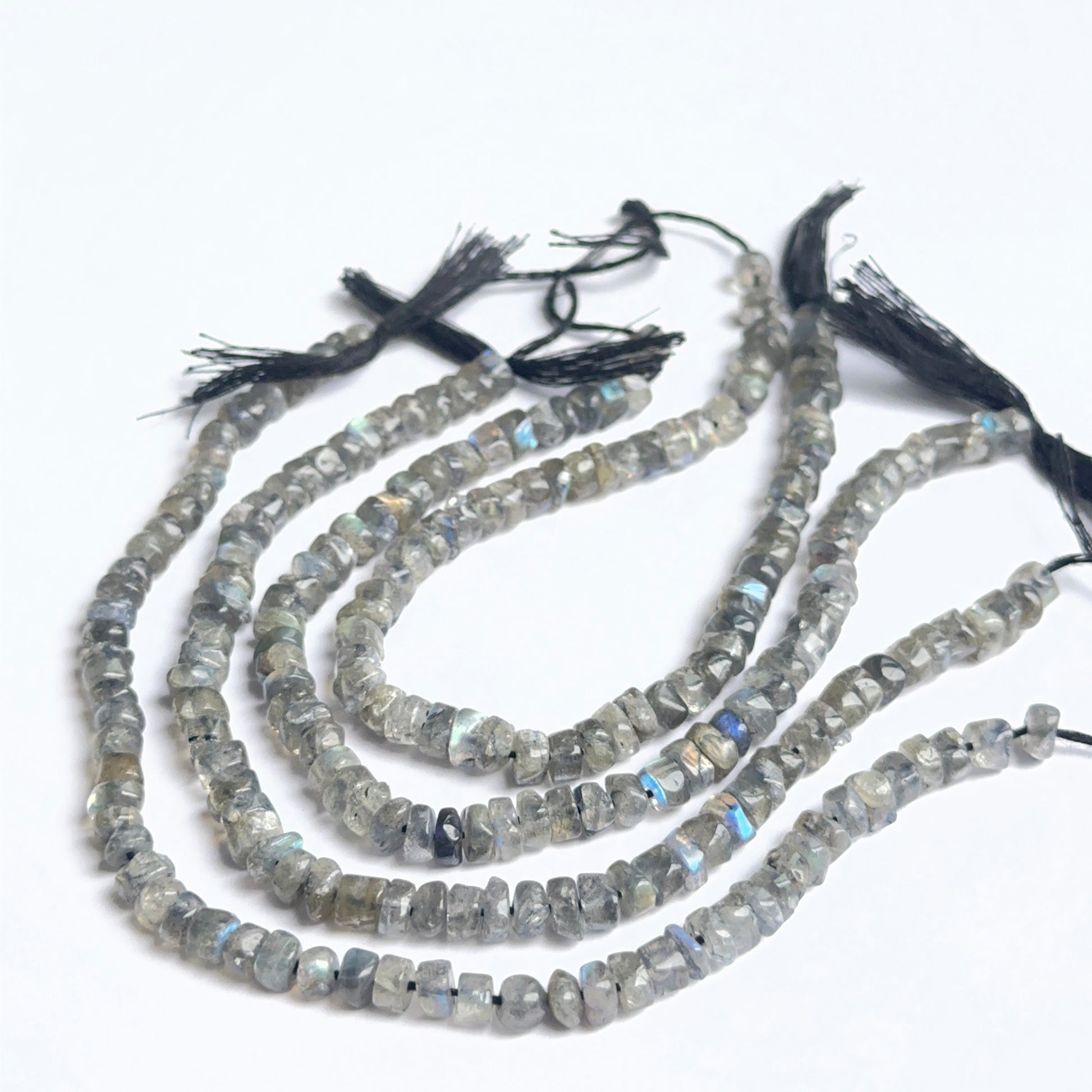 Labradorite smooth wheel heishi beads showing natural flash and polished surfaces for handmade jewellery.