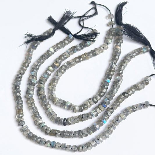 Labradorite wheel heishi beads arranged neatly to showcase uniform shape, colour and gemstone quality.