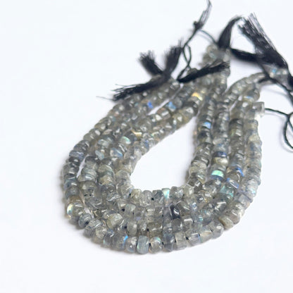 Smooth wheel labradorite beads displayed with clean surfaces ideal for gemstone jewellery making.