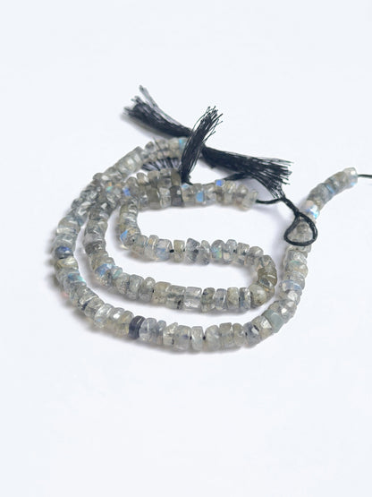 Delicate strands of labradorite smooth wheel heishi beads, showcasing their smooth design.