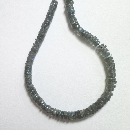 Close-up of Labradorite stone beads with smooth wheel cut, showcasing blue and green flashes for handmade jewellery components.