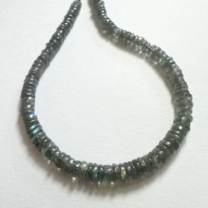 Natural gemstone beads for DIY jewellery featuring 5.1-5.4mm Labradorite wheels with polished finish and iridescent tones.