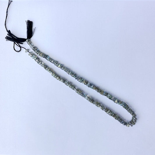 High-grade Labradorite wheels with 0.5mm bead holes and subtle iridescent tones.
