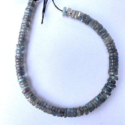 Labradorite smooth wheel beads in 6-6.2mm size with grey base and blue flashes on a 20cm strand.
