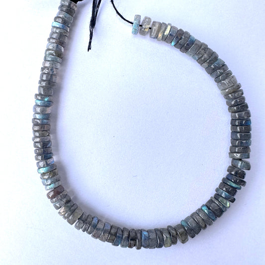 Labradorite smooth wheel beads in 6-6.2mm size with grey base and blue flashes on a 20cm strand.