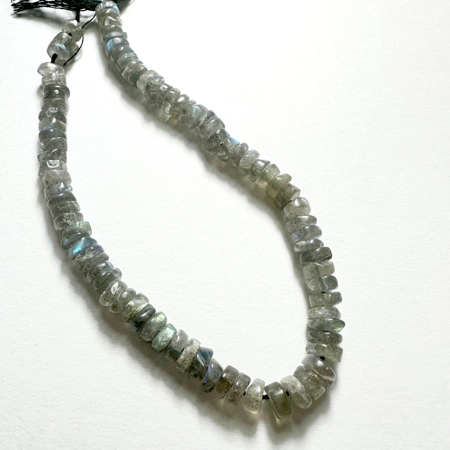 Natural gemstone beads for DIY jewellery featuring 6-6.2mm Labradorite wheels with polished finish and iridescent tones.