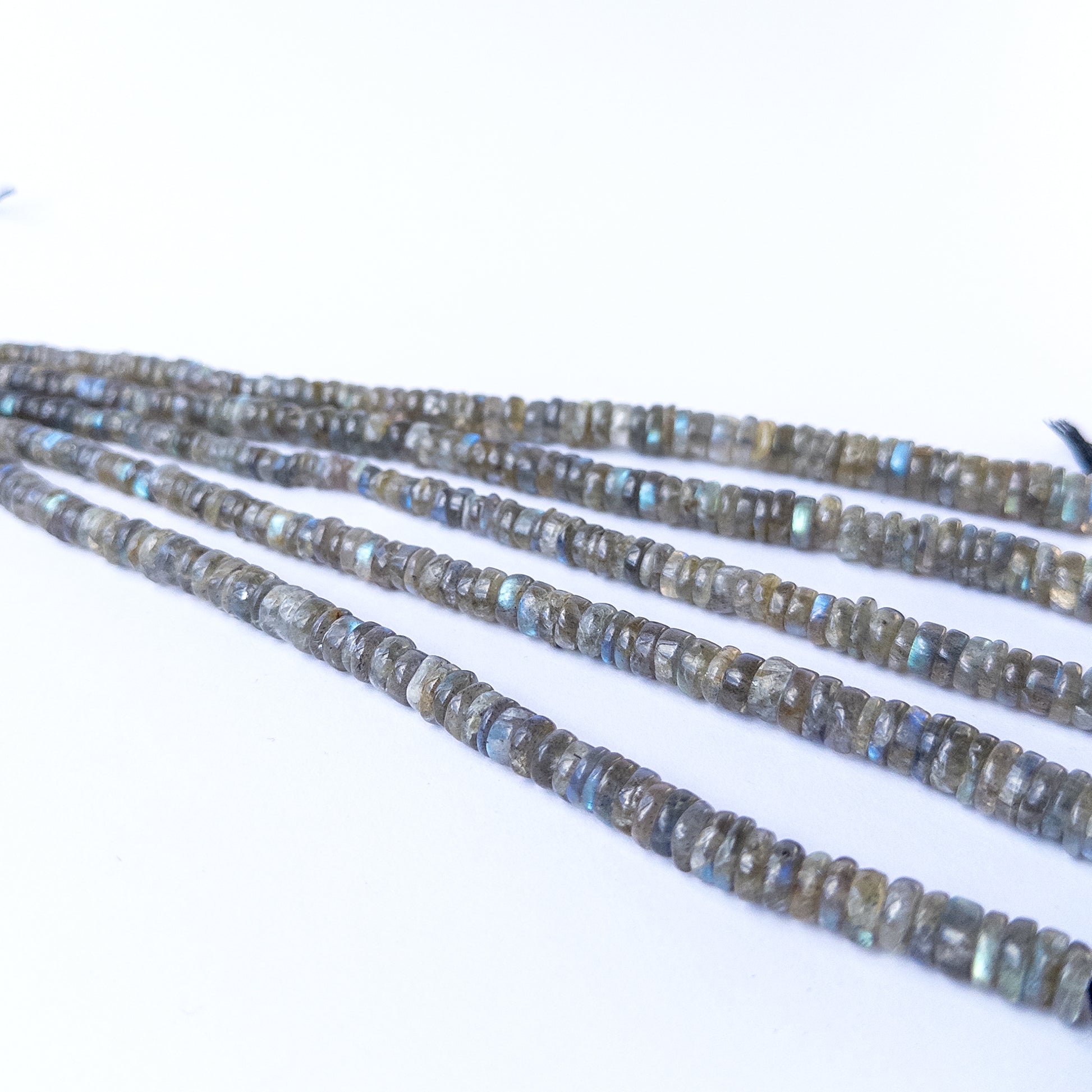 Close‑up of natural Labradorite gemstone beads with smooth wheel shape, perfect for gemstone beads for DIY jewellery.