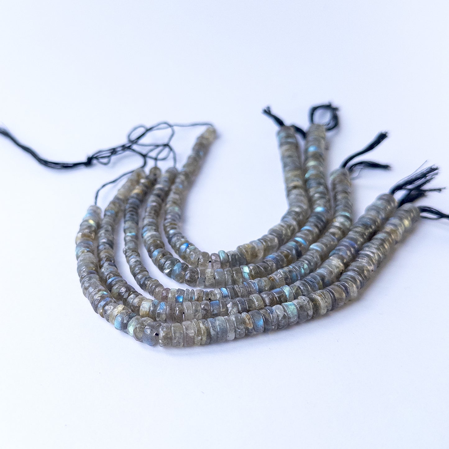 Labradorite smooth wheel gemstone beads showing natural labradorescence on a 20cm strand for handmade jewellery components.