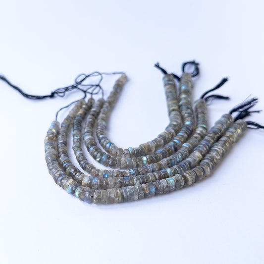 Labradorite smooth wheel gemstone beads showing natural labradorescence on a 20cm strand for handmade jewellery components.