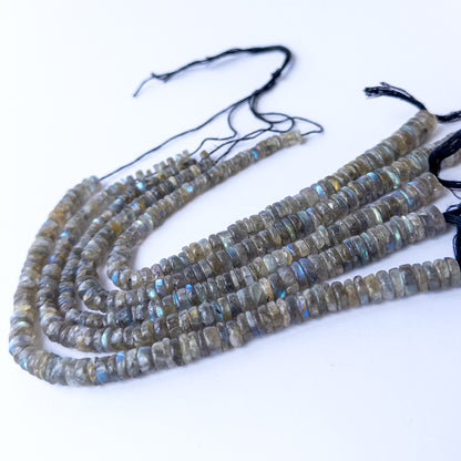 Authentic Labradorite smooth wheel beads arranged on a strand, showcasing natural shimmer and quality polish.