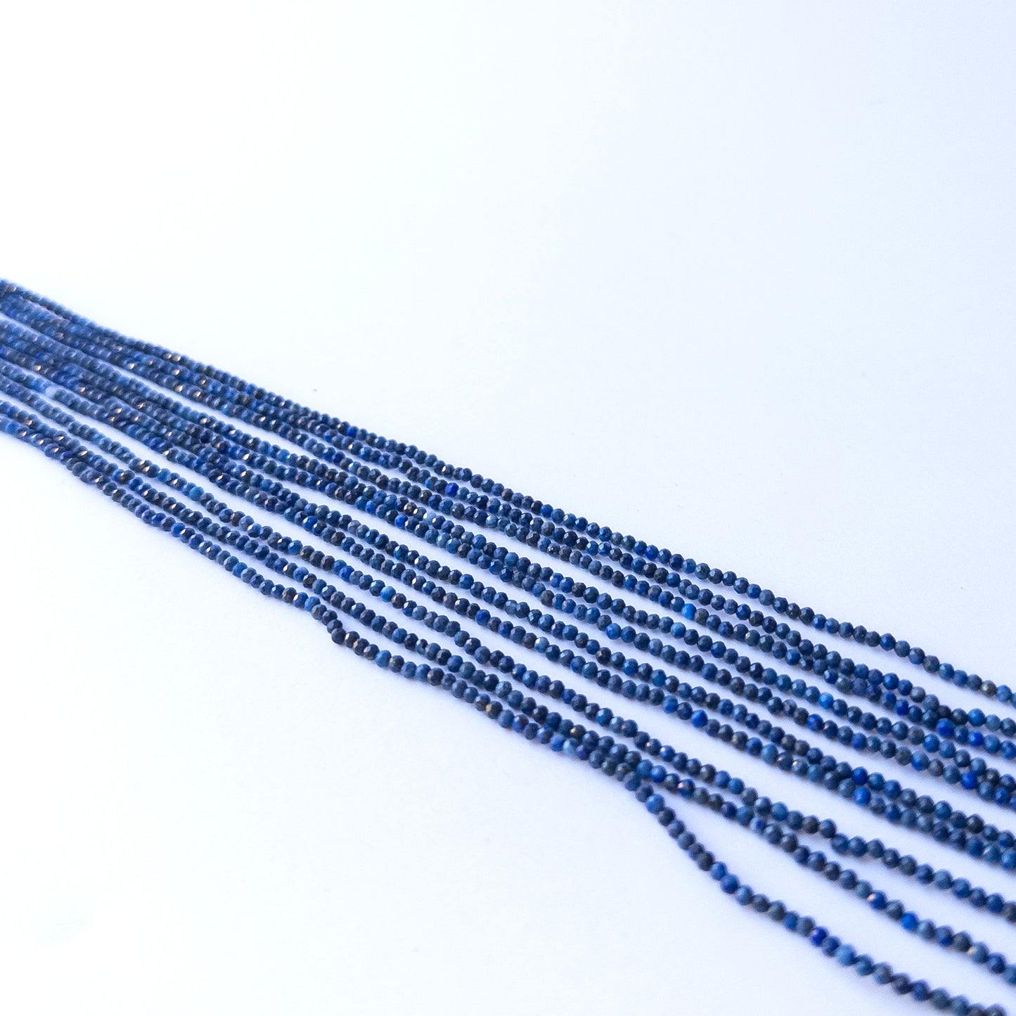 Strand of lapis lazuli faceted rondelles displaying rich blue colour and quality cut for gemstone beads for DIY jewellery.