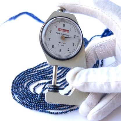 A dial gauge measures the Lapis Lazuli Faceted Rondelle 3.2mm gemstone.