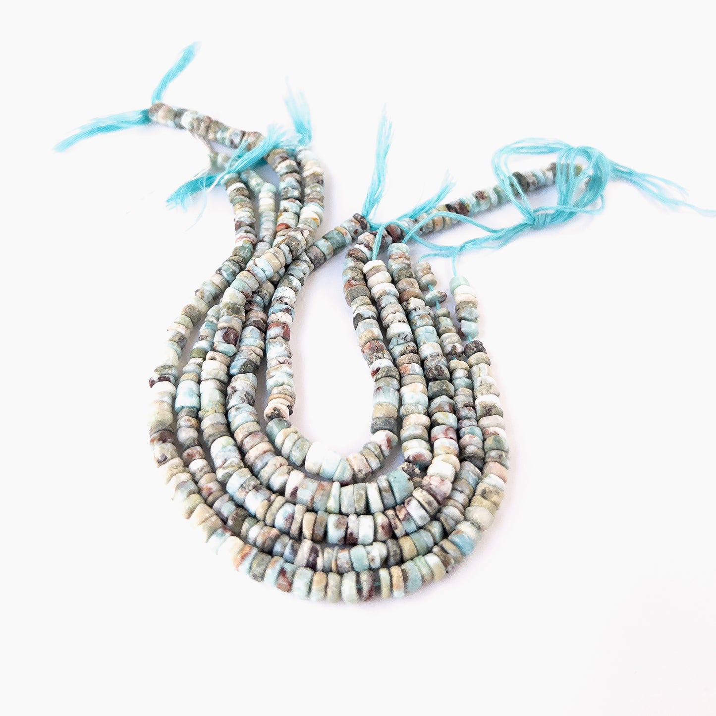 Premium Larimar wheel beads showcasing polished surfaces and natural Caribbean‑blue colour.