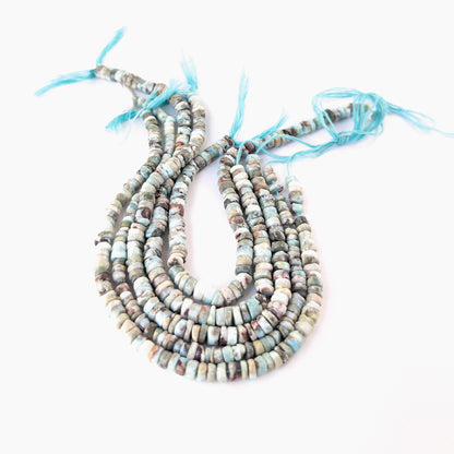 Premium Larimar wheel beads showcasing polished surfaces and natural Caribbean‑blue colour.
