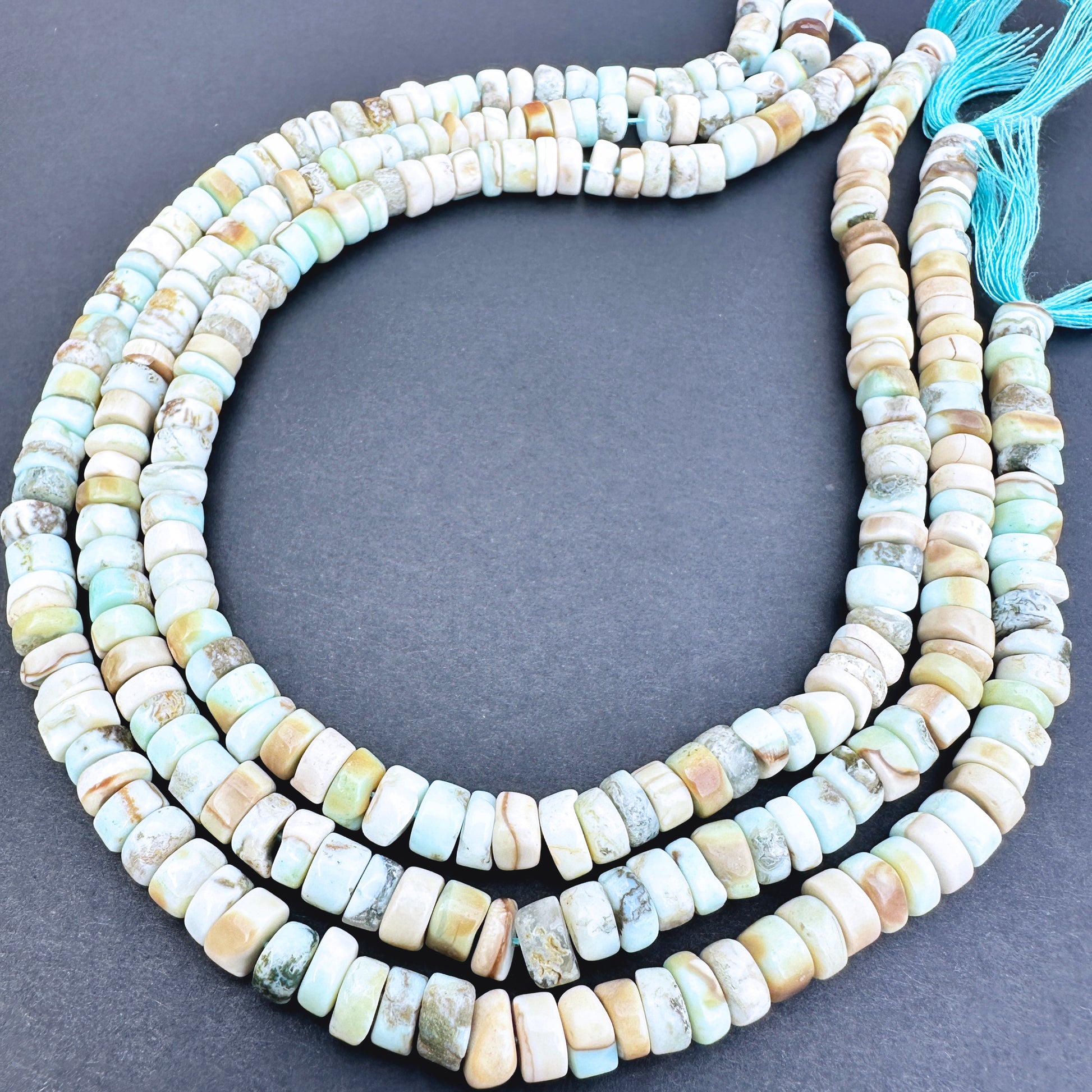 Larimar stone beads with smooth wheel cut and polished surface.