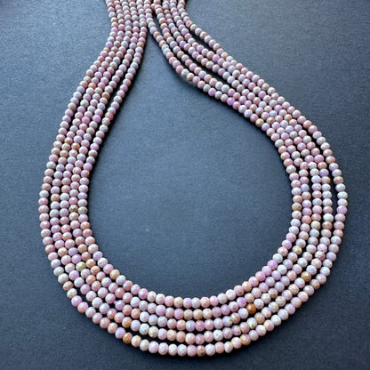 Lavender Opal faceted rondelle beads arranged in a neat strand, showcasing natural gemstone beads for DIY jewellery.