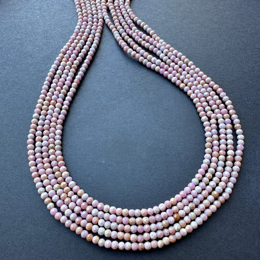 Lavender Opal faceted rondelle beads arranged in a neat strand, showcasing natural gemstone beads for DIY jewellery.
