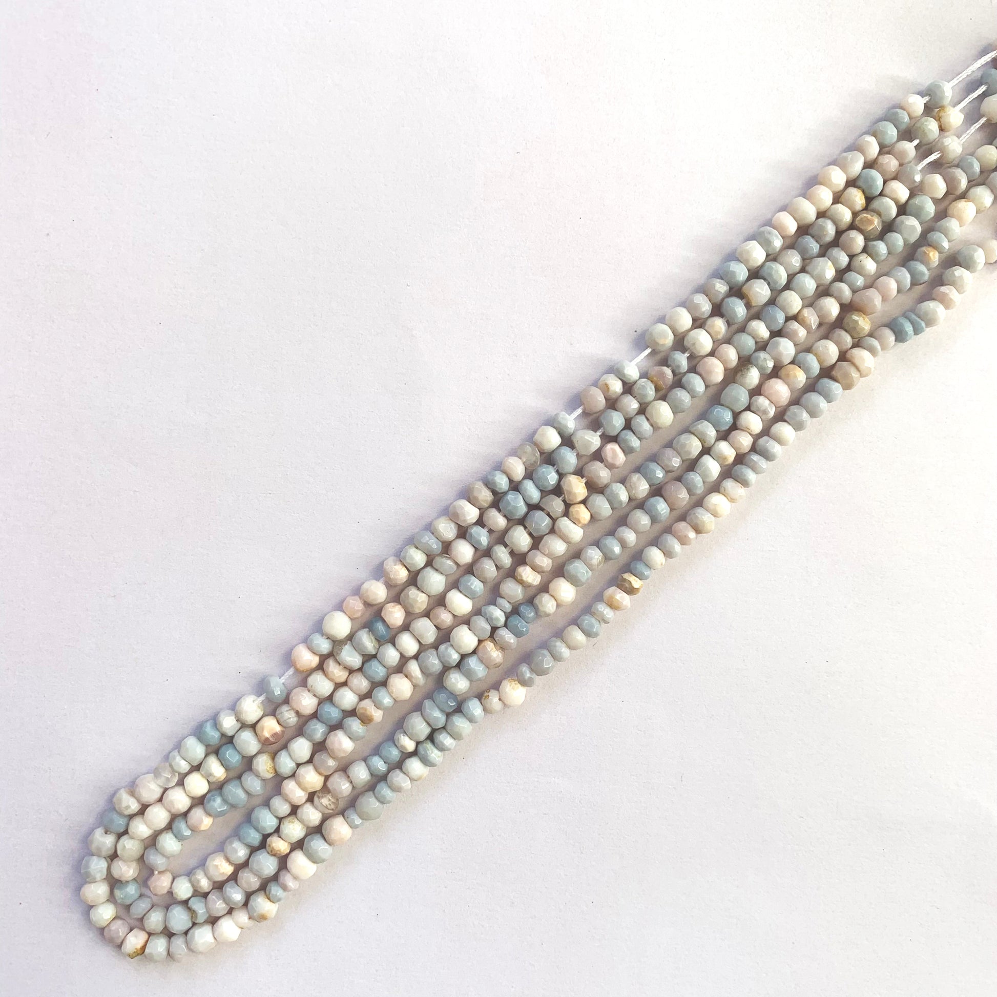 Lavender opal faceted rondelles reflecting light on a clean 32cm thread.